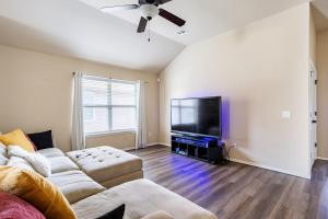 a living room with a couch and a flat screen tv at Cheerful 3 Bdrm space, 2 bath!. You gotta love it! in Oklahoma City