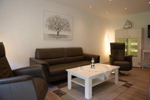 a living room with a couch and a table at Olivia in Norden