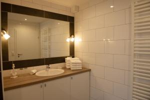 a bathroom with a sink and a mirror at Deichnähe - G in Norddeich +2 photos