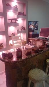 a room with a counter with a laptop and a table at Spring house in Qaryat Shākūsh