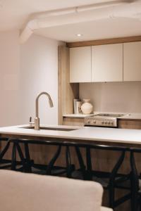 a kitchen with a sink and a counter top at Bakan- Quartier des Congres, Convention District in Montreal