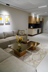 a living room with a couch and a coffee table at Suites El Ghailani in Dakhla