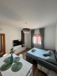 a bedroom with a bed and a table and a couch at Soleo guesthouse in Monza