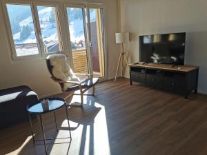 TV a/nebo společenská místnost v ubytování Chuenislodge2- zwei Balkone, gemütlicher Kamin, top Aussicht