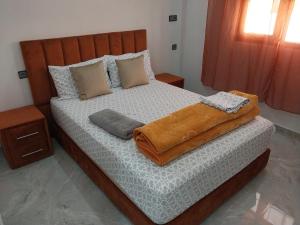 a bedroom with a large bed with pillows on it at Casa Salvador 1 boujdour in Cabo Bojador