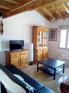 a living room with a couch and a table at A Casa da Boa Xente VUT-OU-1329 in Verín +7 photos