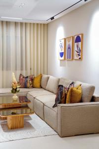 a living room with a couch and a table at Suites El Ghailani in Dakhla