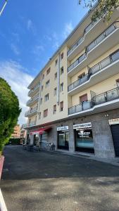 a large building with a parking lot in front of it at Soleo guesthouse in Monza