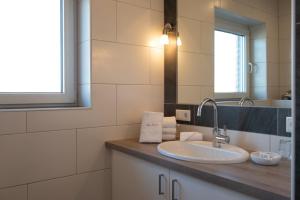 a bathroom with a sink and a mirror at Mole links in Norddeich