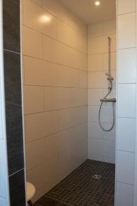 a shower with a glass door in a bathroom at Mole links in Norddeich