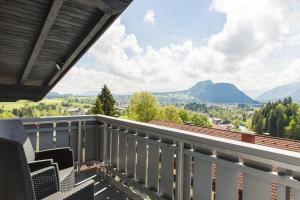 a balcony with a view of the mountains at Wildgrün Panorama Lodge 8b in Pfronten +4 photos