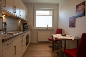 a kitchen with a table and a small table and a window at Florence in Norden