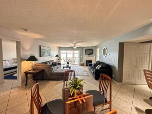 a living room with a couch and a table at Lakefront Condo Wdockdeckpools-sleeps 6 in Lake Ozark