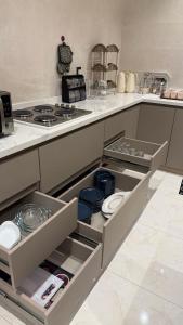 a kitchen with an open drawer with dishes in it at شقة البدر in Medina