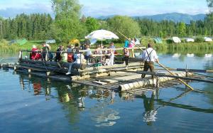 a group of people sitting on a raft in the water at Alpenlodge Lechbruck Allgäu - Fewo 13, hochwertige Ausstattung, Allgäu, inkl Golf-Rabatt, Lechbruck am See in Helmenstein +3 photos