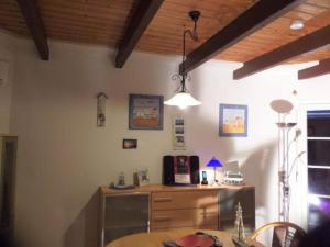 a dining room with a table and a lamp at Strolchi in Dorum-Neufeld
