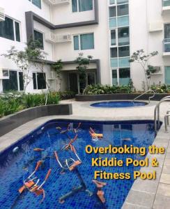 a swimming pool in front of a building at STARK's SUITE3 A MODERN studio-unit in MEGAWORLD in Iloilo City