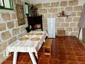 a room with two beds and a white refrigerator at Casa Rural La Sombrera in Fasnia