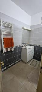 a bathroom with a sink and a mirror at Appartement de type F3 in El Kseur +3 photos