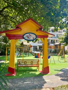 a playground with a bench in a park at Barra Family Resort com piscina e spa, 2 quartos in Rio de Janeiro +20 photos