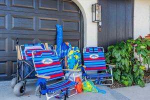 two beach chairs sitting in front of a garage at Saltwater Siesta Game Room Pool Mini Golf in Sarasota