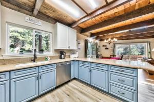 a kitchen with blue cabinets and wooden ceilings at Stay Cool! AC - Foosball - Nature Escape in South Lake Tahoe