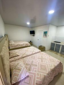 Voodi või voodid majutusasutuse Posada Three Cay Suites toas