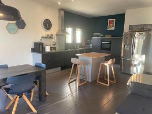 a kitchen with a table and chairs and a refrigerator at Villa in Vaison near Roman Ruins & Pool in Vaison-la-Romaine +32 photos