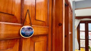 a wooden door with a sign on it at Casa Nazimova Indigo Room in San Cristóbal de Las Casas