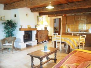 a living room with a table and a kitchen at Private Garden House in Redortiers in Redortiers