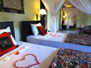 Postel nebo postele na pokoji v ubytování Taruna Boutique Homestay & Spa