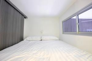 ゲンティンハイランドにあるMidhills Genting Highlandsの大きなベッドと窓のある寝室