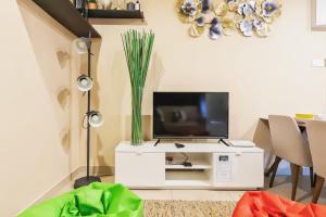 a living room with a tv on a white cabinet at Midhills Genting Highlands in Genting Highlands