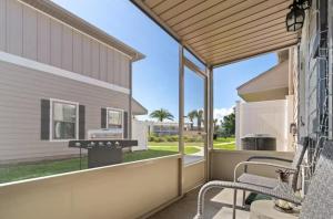 a screened porch with a bench and a grill at Pensacola Paradise Downtown in Pensacola