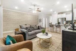 a living room with a couch and a table at Pensacola Paradise Downtown in Pensacola
