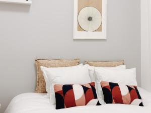 a bedroom with a bed with white sheets and pillows at Soar Home l Airport l Olivais in Lisbon +17 photos