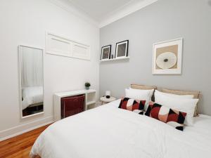 a white bedroom with a bed and a fireplace at Soar Home l Airport l Olivais in Lisbon