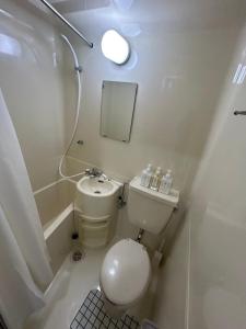a small bathroom with a toilet and a sink at SABBATH uzumasa 101 in Kyoto +41 photos
