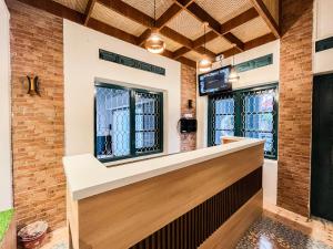 a bar in a building with windows at RedDoorz Near Alun Alun Blitar in Karangtengah