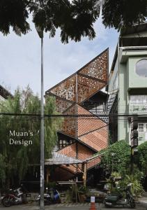 a building with a spiral staircase in front of it at Muan Hotel in Chiang Mai