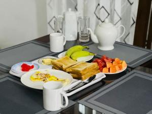 a tray of breakfast foods on a table at Golden Paradise Transit Hotel in Katunayaka