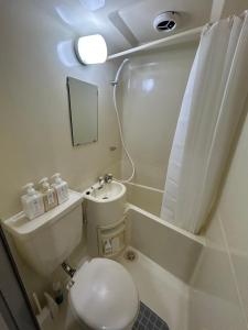 a small bathroom with a toilet and a sink at SABBATH uzumasa 102 in Kyoto +34 photos