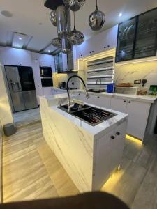 a kitchen with a sink and a counter top at Luxury Smart Retreat Home in Lagos +6 photos