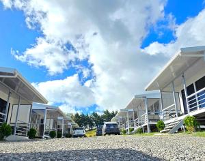 a row of buildings with cars parked in a parking lot at Cattleya Living Studio in Monteverde Costa Rica