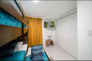 a bedroom with a bunk bed and a chair at House in the Heart Of Miami in Miami