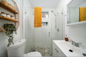a bathroom with a shower and a toilet and a sink at House in the Heart Of Miami in Miami +20 photos