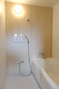 a bathroom with a bath tub and a shower at Vantean house - Vacation STAY 94009v in Biei +27 photos