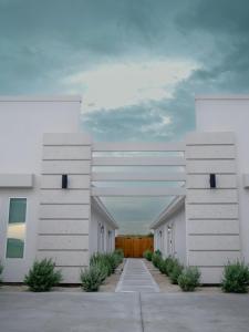 a row of white buildings in a parking lot at Premier Luxe Villa in Weslaco
