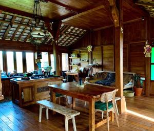 a kitchen with a wooden table and a dining room at Rumah Pacung in Penebel