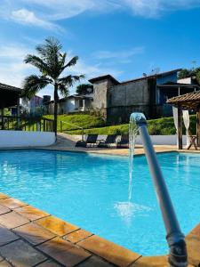 una piscina con una fuente en el medio en Prime Garden Pousada, en Socorro